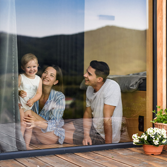 modern kitchen and dining area with large glass doors open to garden featuring sleek design and outdoor seating perfect for entertaining