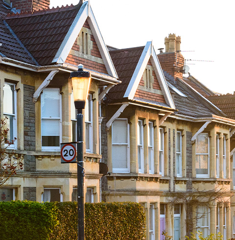 colorful houses with blue and yellow walls and white trim showcasing unique architectural details and two vibrant shades